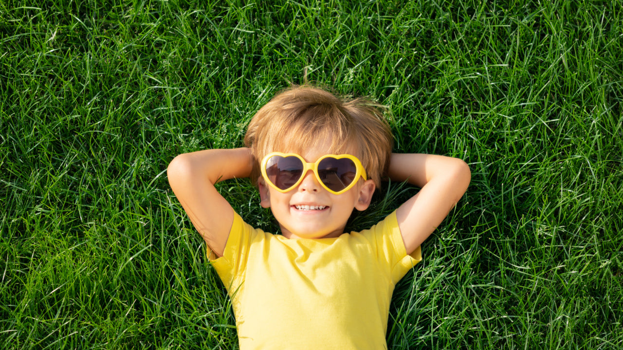 toddler girl sitting showing thumb